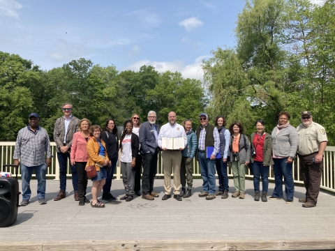 Urban Bird Treaty partners of Hartford stand together at Keney Park posing with the signed treaty