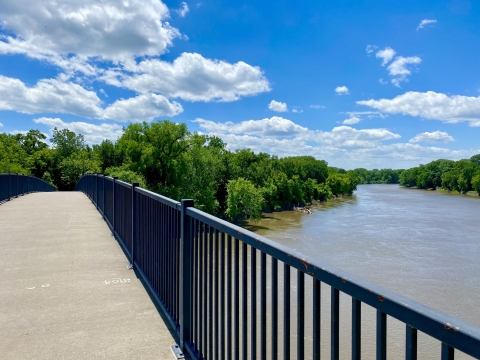 River view from on top of a bridge on a sunny, summer day