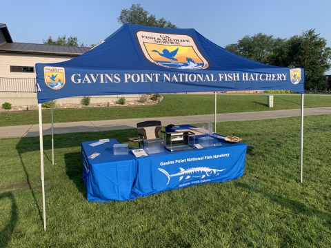 Pop up canopy shelter with several Fish and Wildlife Service logos.