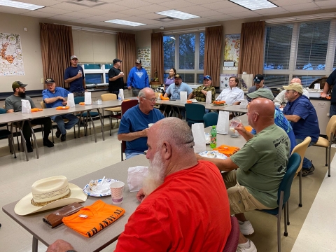 Group of people having a meal in a classroom