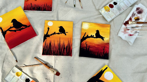 Painting space of five art canvases of a bird on a branch with a sky showing warm tones