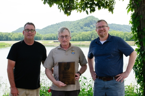 Kurt Schilling and Tim Patronski present Doug Alosi with an award plaque