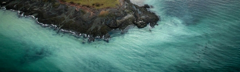 milky turquoise water off a rocky coast