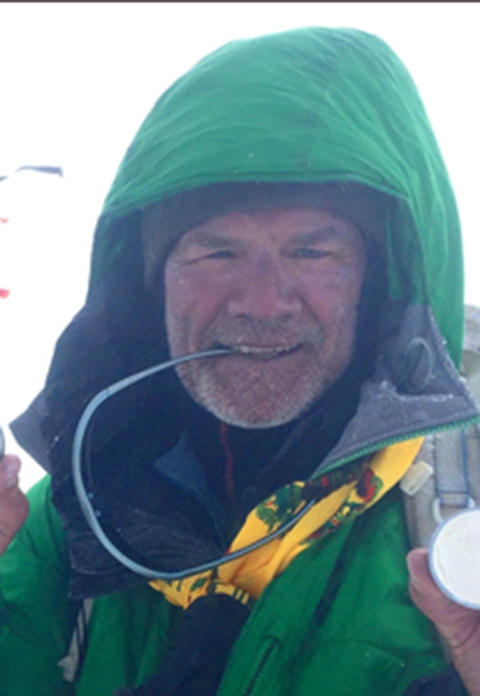 person headshot with green hooded jacket