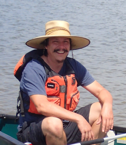 person smiles in boat