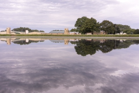 A wide shot of a pond and buildings at Gavins Point NFH