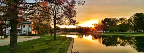 Tree lined pond and visitor center at the Neosho National Fish Hatchery