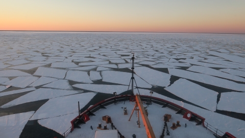 Ice breaks in the arctic ocean with a view from the bow of a ship