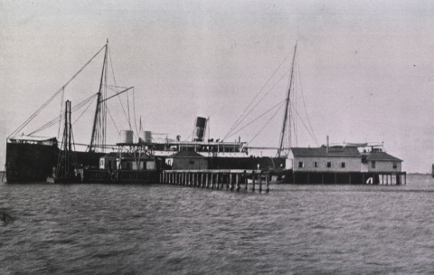 And old black and white photo of a ship and Blackbeard wharf.