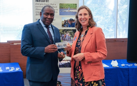 Assistant Director for Migratory Birds, Jerome Ford, stands with Director Martha Williams as they hold the newly issued duck stamp.