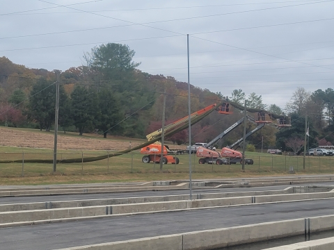 USDA collaborative partner using lifts to install top netting section