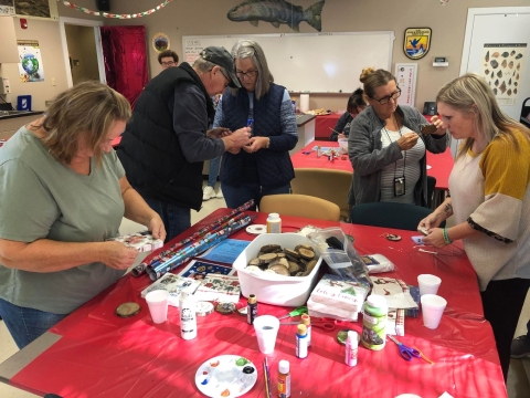 People gathered around a table making crafts