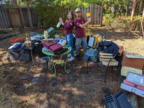 Service interns pose with cleaning gear and over 20 used tackle boxes they cleaned out.