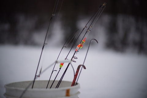 bucket of icefishing rods