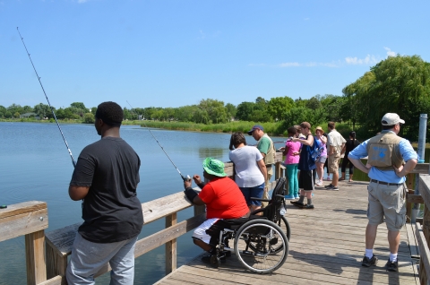 A diverse of anglers on a fishing pier.