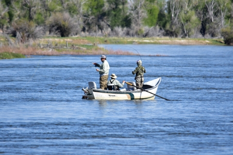 3 people in boat fishing