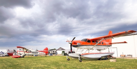 Migratory Bird Program Daher Kodiak survey plane in front of the International Federal Pavilion at EAA AirVenture convention