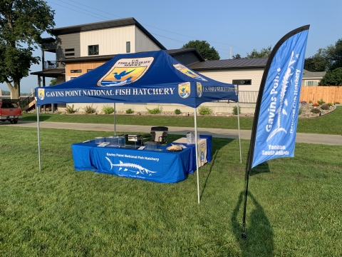 Pop up canopy shelter with several Fish and Wildlife Service logos.