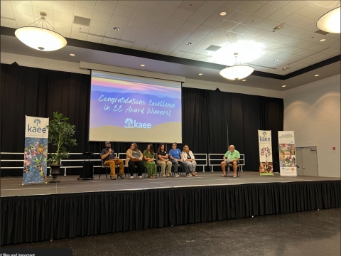 People seated on stage for a interview panel