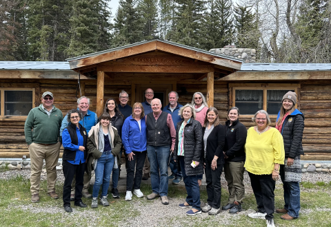 Image of group standing in front of cabin
