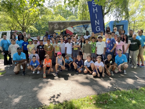 Participants pose for a group photo at the 2024 Cops and Bobbers Fishing Event as part of the Elizabeth Urban Wildlife Refuge Partnership at Warinanco Park in Elizabeth, New Jersey
