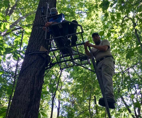 Fish and Wildlife Service employees repairing deer stand