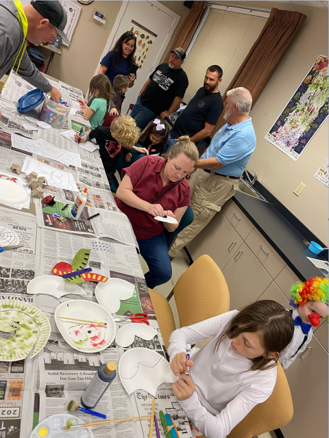 People doing insect crafts 