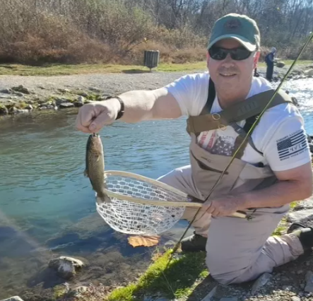 Fly fisherman with his catch 