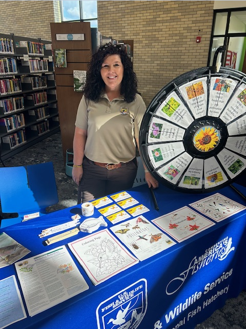 USFWS employee behind table at event 