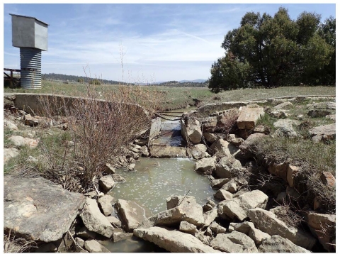 A flume barrier, a water control structure, preventing water overflow.