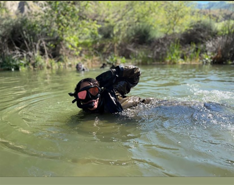 A woman wearing snorkeling gear floating in the water