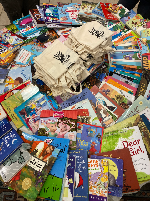 a pile of colorful books on a table arranged in a spiral