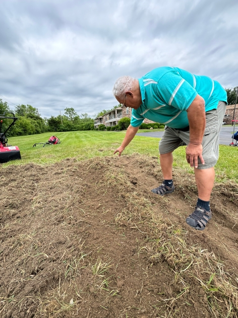 A man provides guidance for a community garden