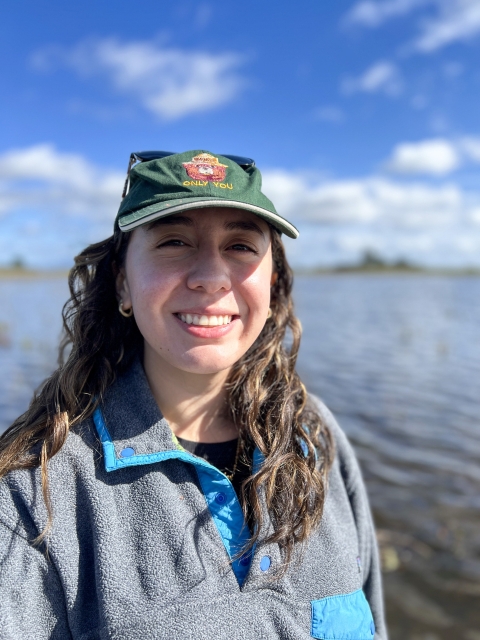 a woman smiling outside. 