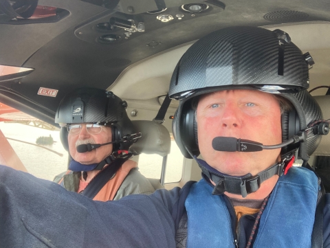 two people with helmets taking a selfie