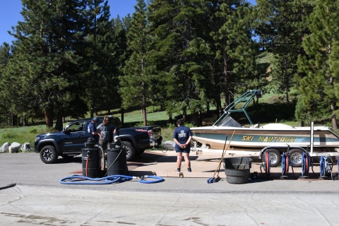 Two staff members inspect a boat for aquatic invasive species in South Lake Tahoe, Calif. 