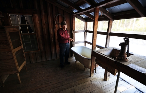 Joe shows the family's first indoor bathtub--a sign they had "made" it.