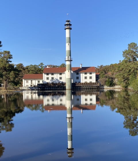 An old building with smokestack alongside a canal.