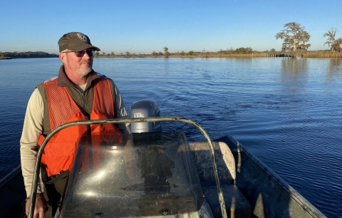 A man steering a boat.