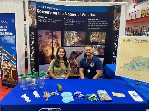 A USFWS employee and volunteer at an informational booth