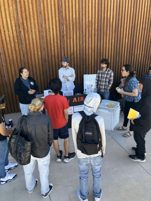 group of people standing and listening to 3 others