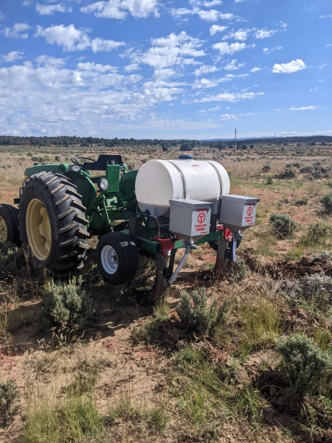 Image of a Yeoman's plow that has tickle seeders on a field