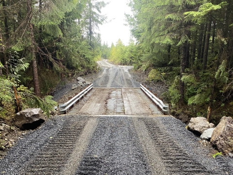 a gravel road meets a bridge