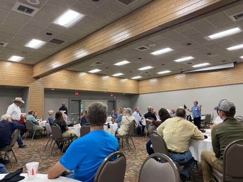 People sitting at tables in conference area