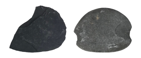 A black stone with three sides carved to a point on one end, and a rounded side on the other end. A gray oval stone carved with parallel rounded long convex sides, and parallel small notched concave sides.