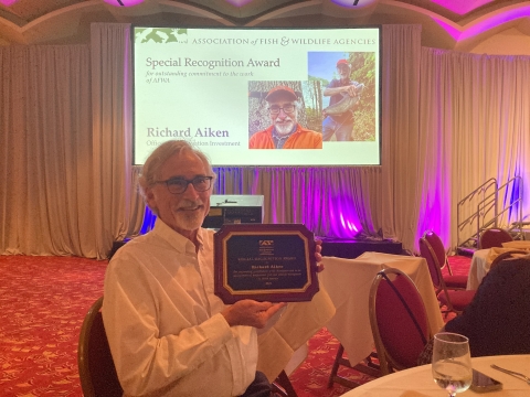 Richard Aiken holds the AFWA awards plaque presented to him by AFWA. 