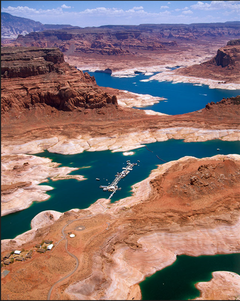 An aerial image of a very blue marina surrounded by geologic rock formations