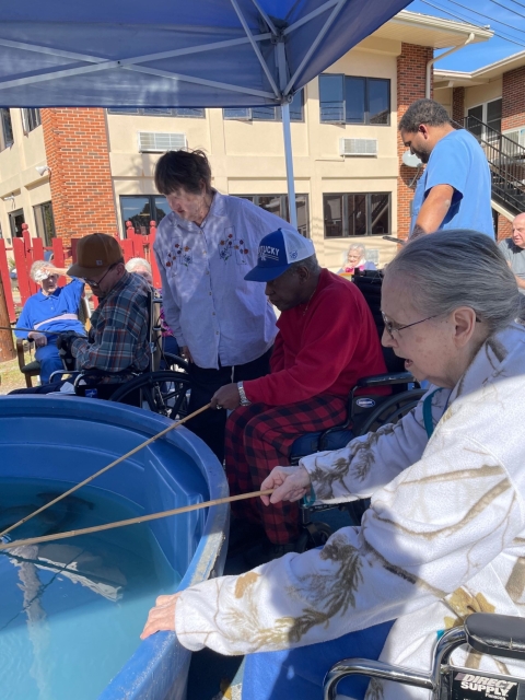 Elderly people fishing in tank