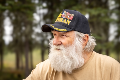 Man with a beard wearing a Marine veteran hat