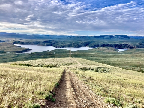 A dirt path leading to a lake